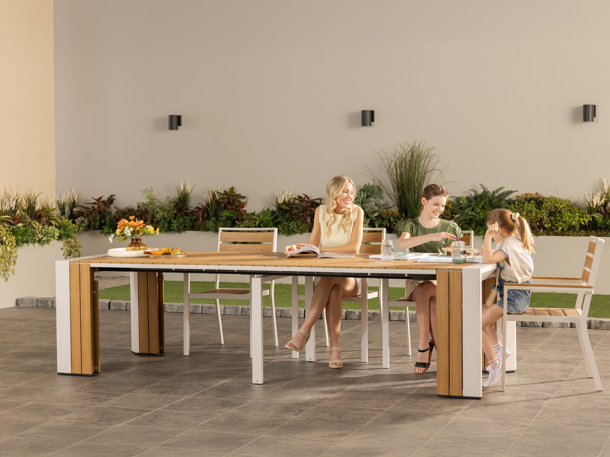 Transformer-outdoor-table-light-teak-the-family-5-panels-lifestyle-models_4baae226-d37b-4d46-8eb5-40e5c7255f88 Transformer Outdoor Chair - Image 1